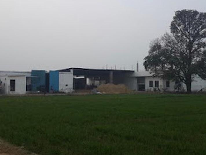 Divin Mushroom Farm buildings beside the fields in Barona, Kharkhoda