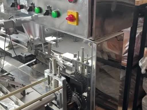 Packing machine for mushroom biscuits at Divin Mushroom Farm